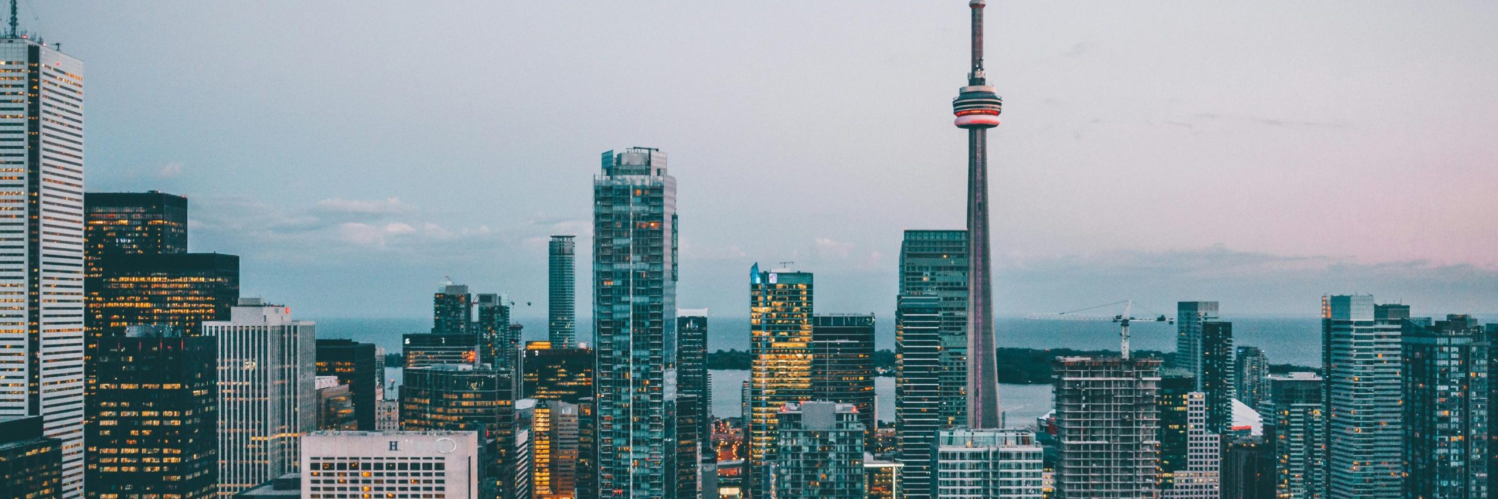 A breathtaking view of Toronto's skyline featuring the iconic CN Tower at dusk.